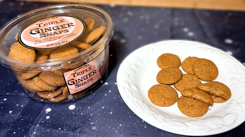 ginger snap cookies on plate next to product package