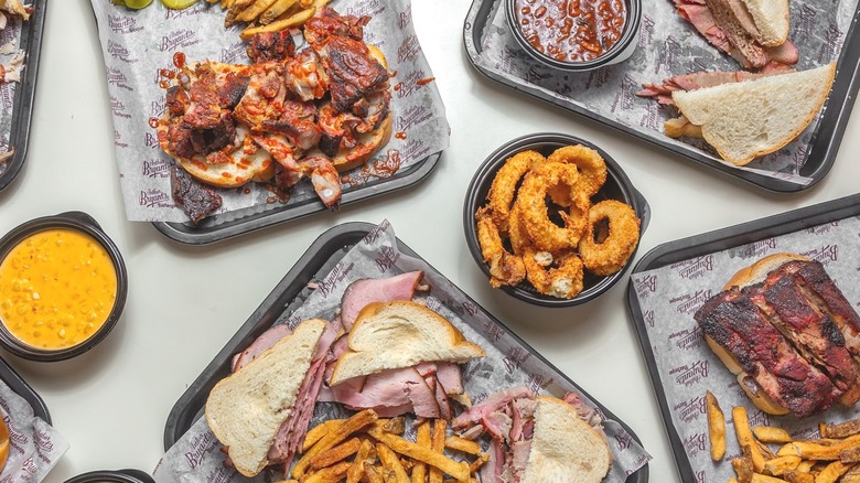 Trays of BBQ with fries and onion rings from Arthur Bryant's Barbeque