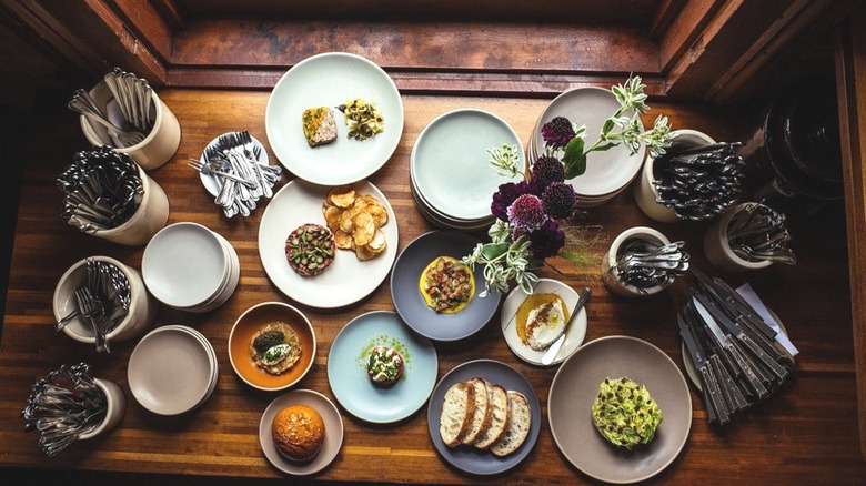 Window table filled with food at Coquette in NOLA