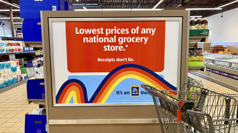 Aldi cart next to sign