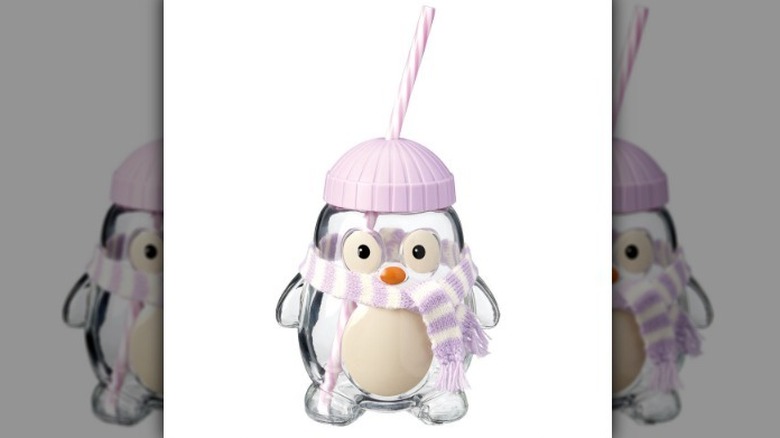 Glass penguin cup on white background