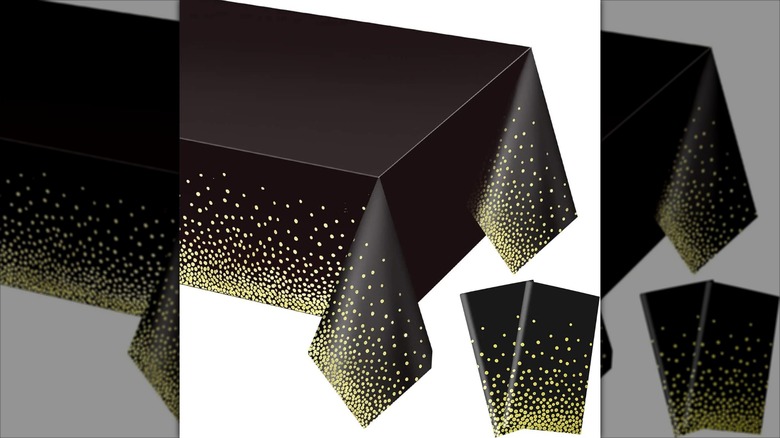 Gexolenu Premium Black and Gold Plastic Tablecloth on table