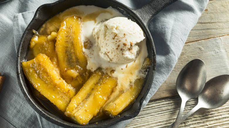Cast iron pan with bananas foster and vanilla ice cream
