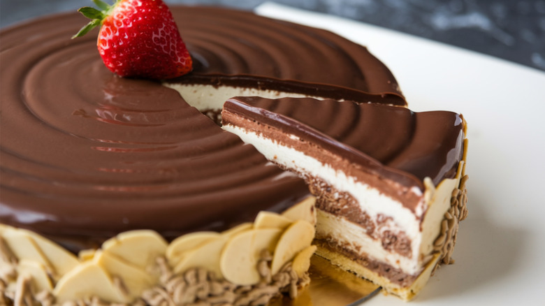 Close-up of Boston cream pie with a slice being removed