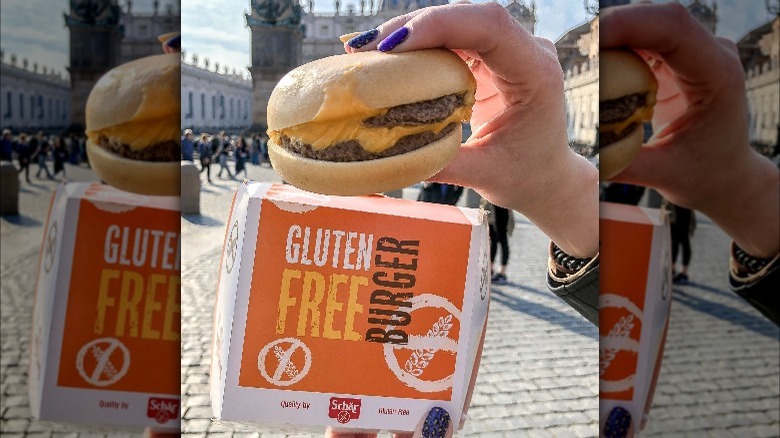 Hand holding gluten free burger