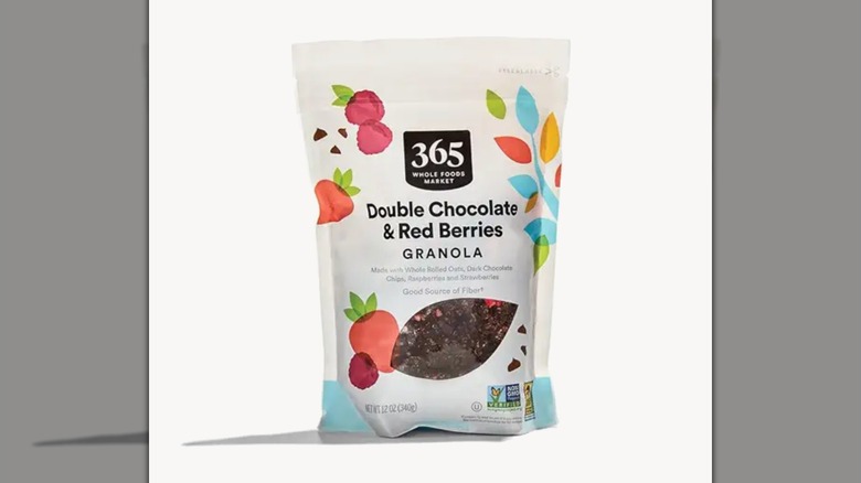 A bag of 365 by Whole Foods Market Double Chocolate Granola with Red Berries on a white background