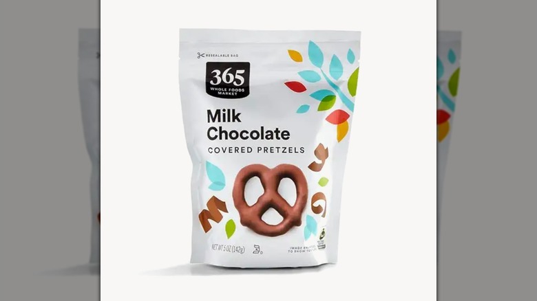 A bag of 365 by Whole Foods Market Milk Chocolate Pretzels on a white background