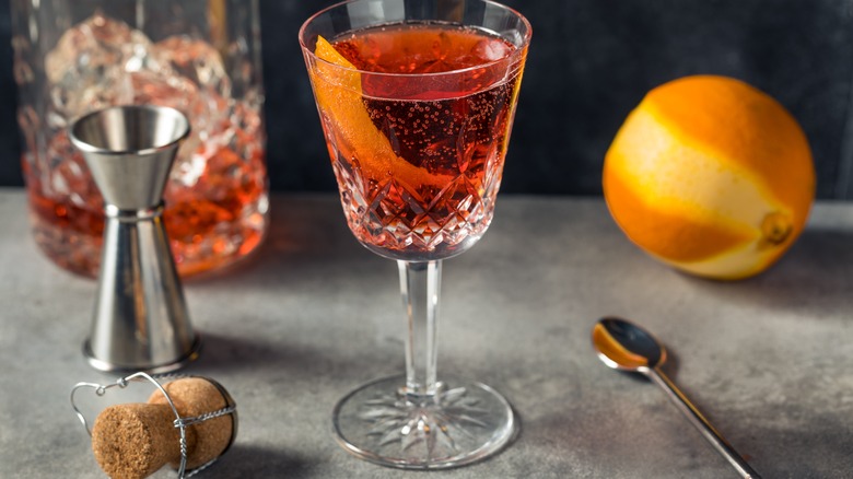 a Negroni Sbagliato surrounded by ingredients and utensils