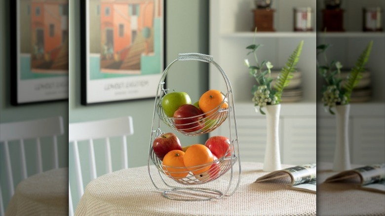Fruit basket with fruit sits on table