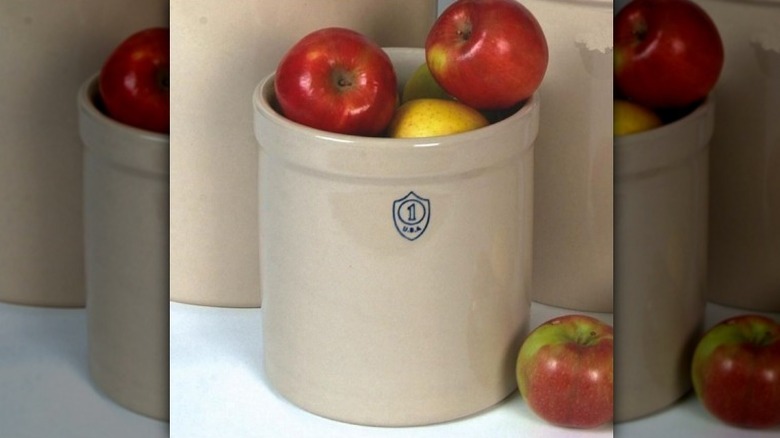 Apples in stoneware crock on kitchen counter.