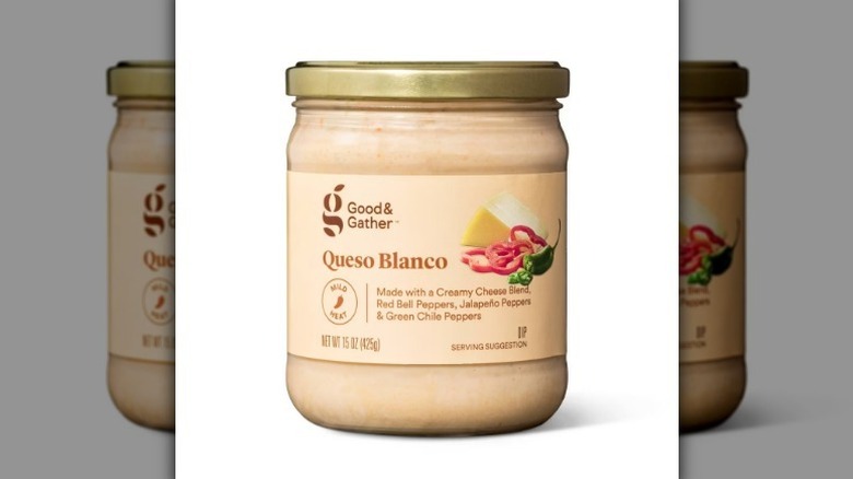 Queso blanco in a jar with a beige label on white background