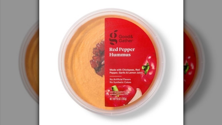 Red pepper hummus with a bright red label on white background