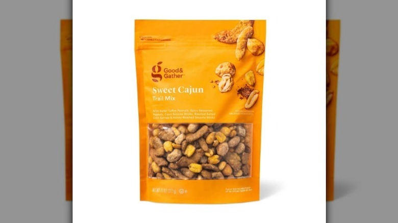 Cajun trail mix in a yellow-orange bag on white background