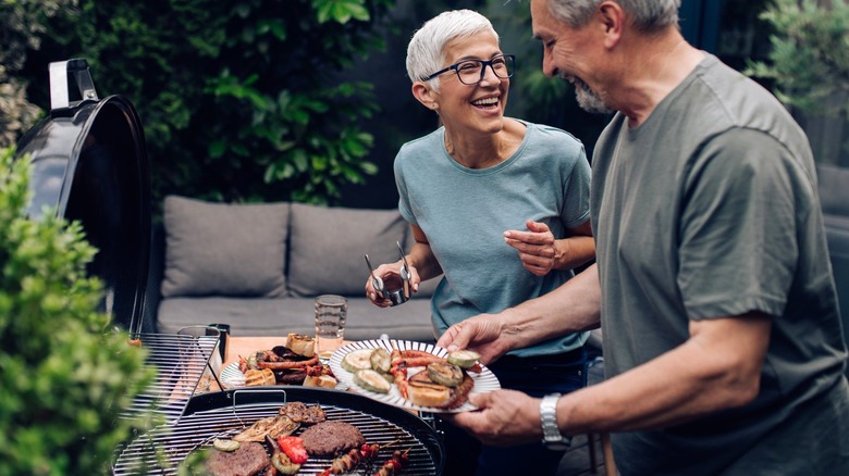 couple standing by grill