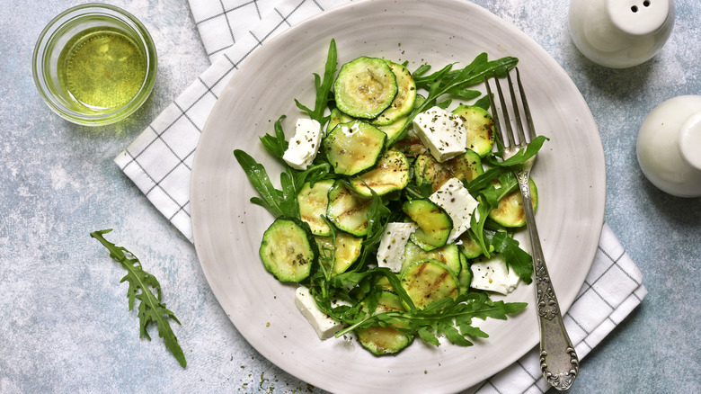 Zucchini salad with cheese and greens