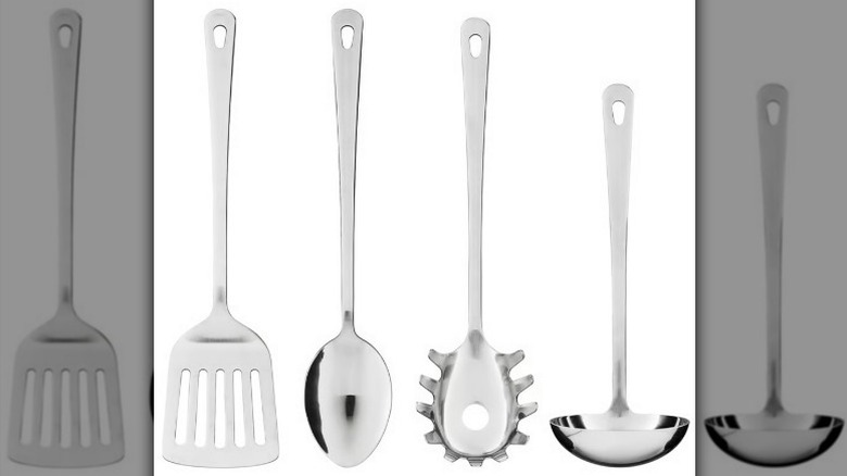 Four-piece stainless steel kitchen utensil set on white background