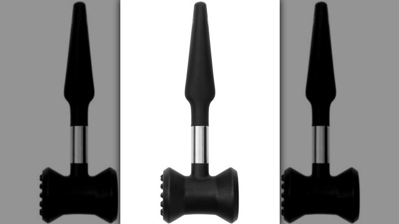 Black and metal meat tenderizer on white background
