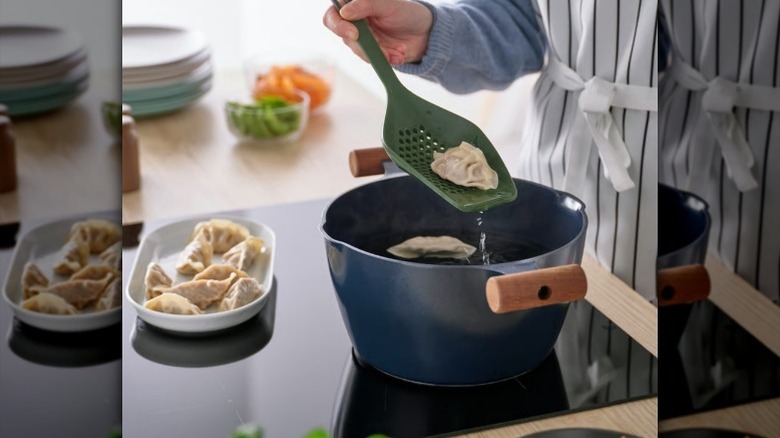 Hand holding multi utensil spoon