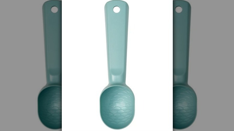 Teal ice cream scoop on white background
