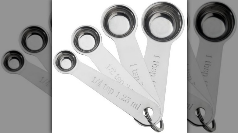 Measuring spoon set with 1/4 tsp, 1/2 tsp, 1 tsp, and 1 tbsp on white background