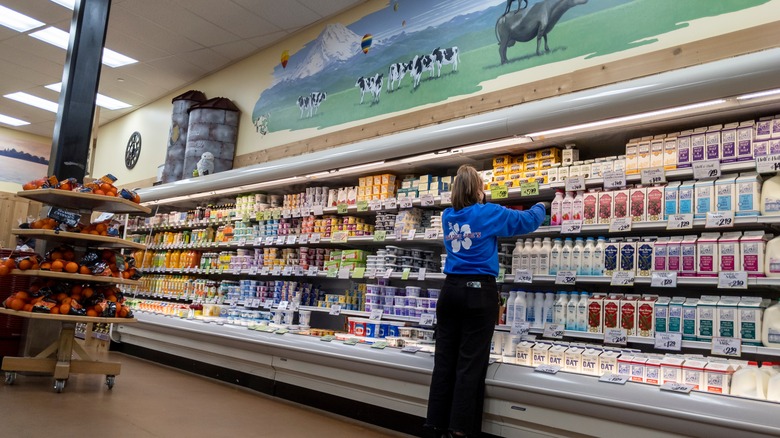Trader Joe's staff member organizing shelves