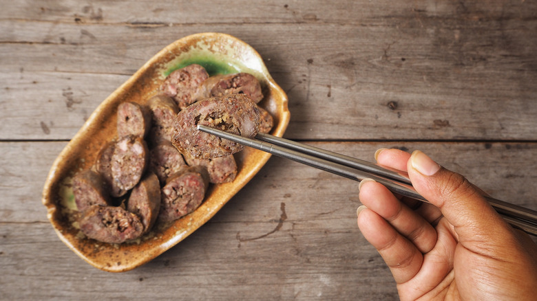 soondae sausage with chopsticks