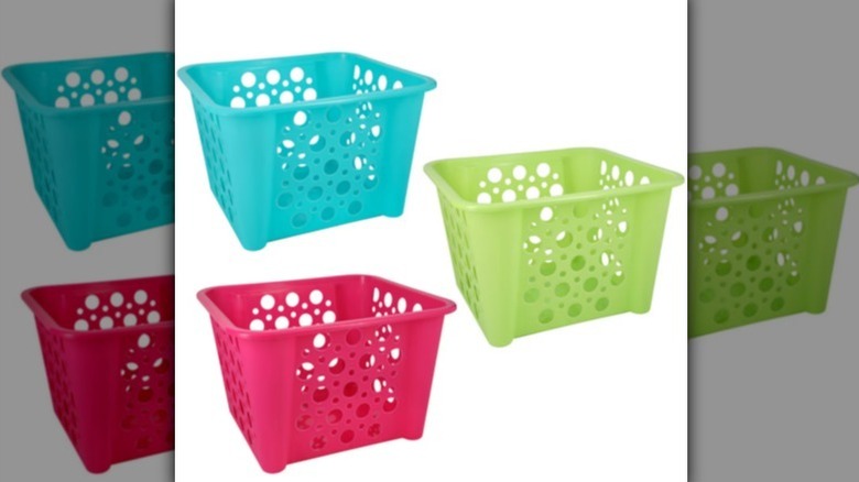 Slotted storage baskets in aqua blue, lime green, and bright pink on white background