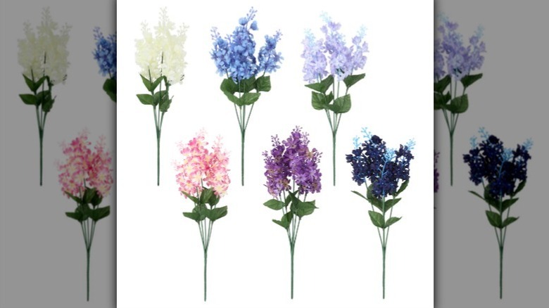 Artificial lilacs in white, blue, lavender, pale pink, purple, and navy blue on white background