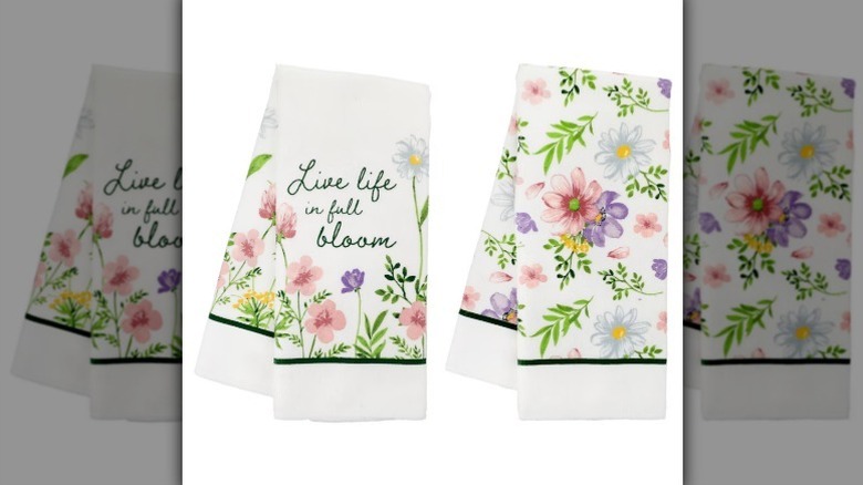 Spring floral towels with text "live life in full bloom" on white background