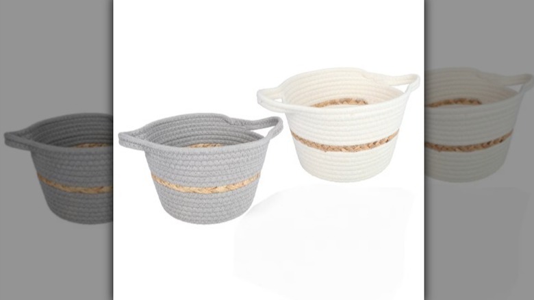 Woven cotton baskets in gray and white with a natural woven stripe on white background