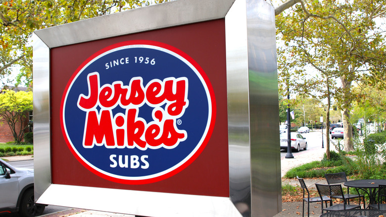 A Jersey Mike's exterior sign in a square, stainless steel frame.