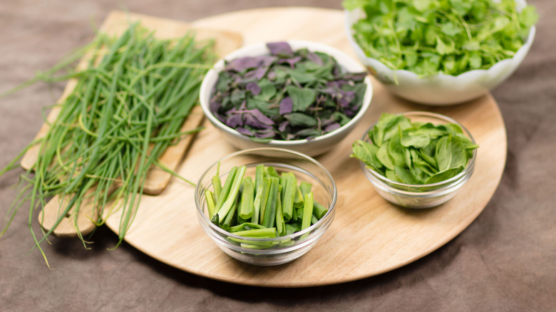 Herbs and greens on a wooden lazy Susan
