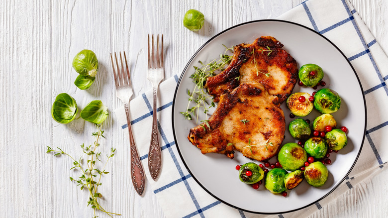 Thin, bone-in pork chops with Brussels sprouts and pin cherries