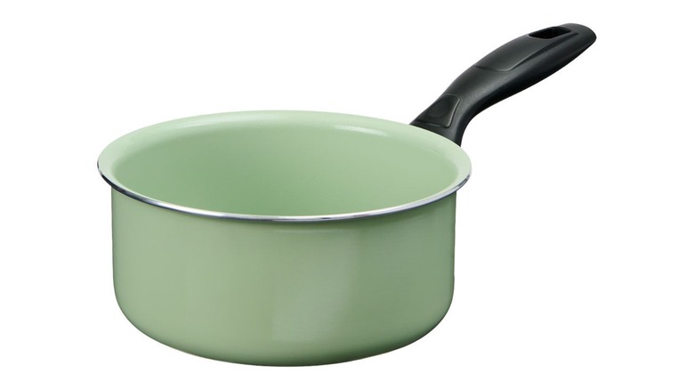 A green ceramic mini saucepan with black handle