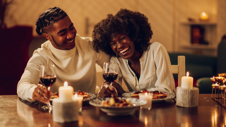 couple laughing at dinner table
