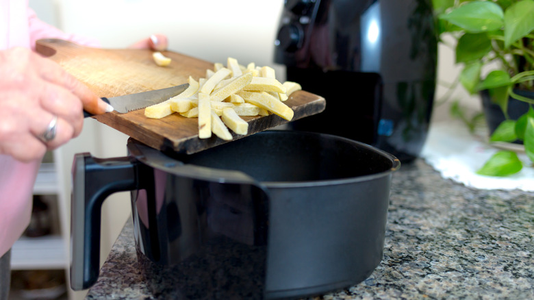putting french fries into air fryer