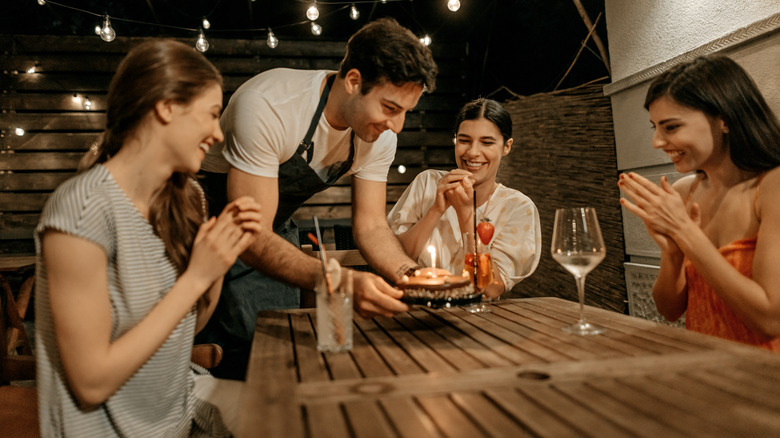 server bringing birthday cake