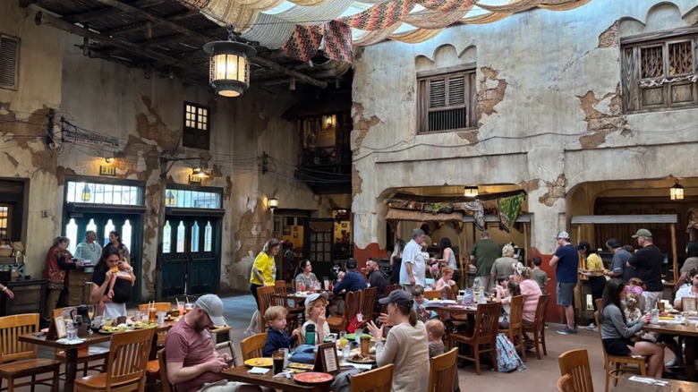 Diners eating inside the faux-rustic interior of Tusker House in Animal Kingdom