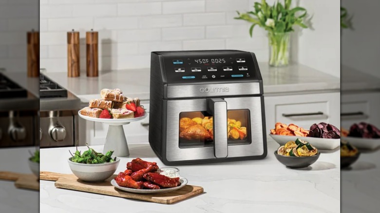 Gourmia 8-Quart Digital Air Fryer on a countertop, surrounded by food