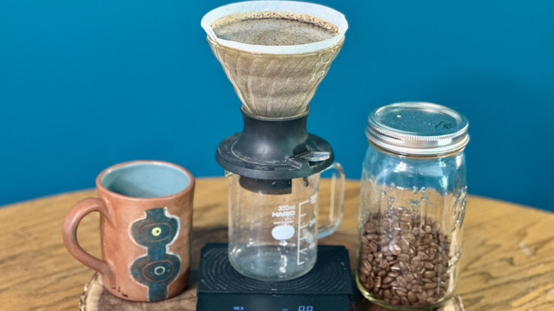 Hario switch on coffee pot and scale, with mug and jar of beans