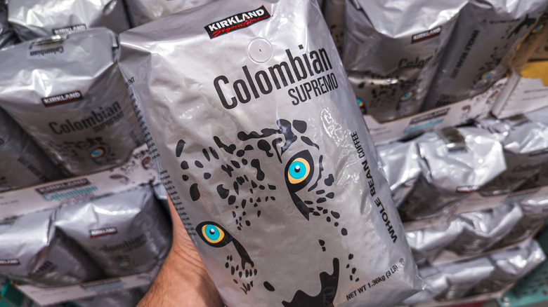 Hand holding bag of Kirkland Colombian coffee