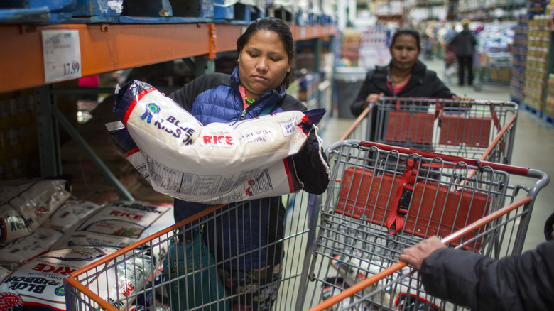 Costco shopper holding bag of rice