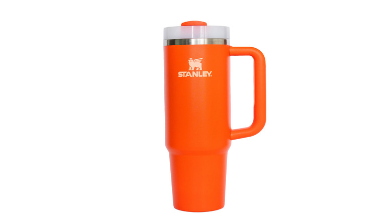 Orange Stanley water bottle against white background