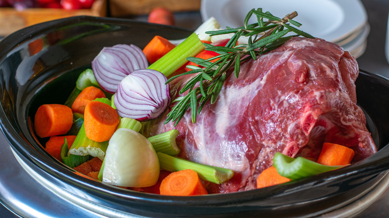Raw meat and veggies in a slow cooker