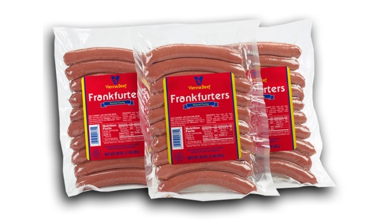 3 packs of Vienna Beef Natural Casing Hot Dogs on a white background.