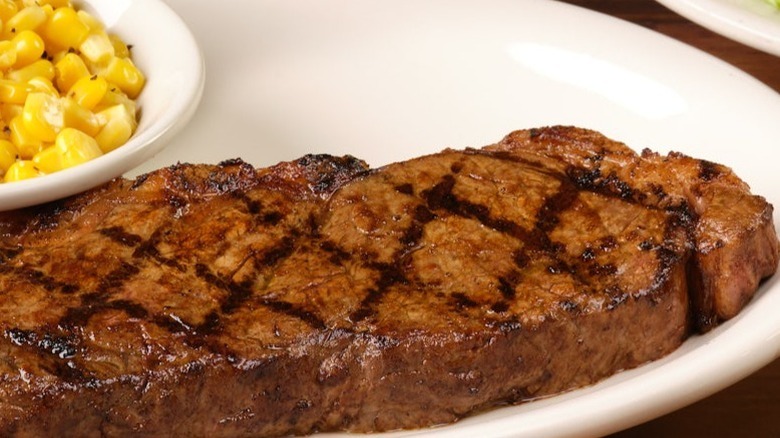 Texas Roadhouse sirloin on a plate with corn