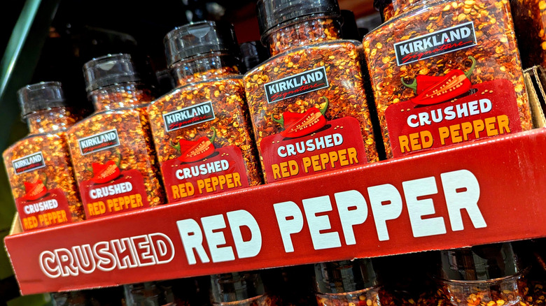 Containers of Kirkland Signature brand crushed red pepper in a store display