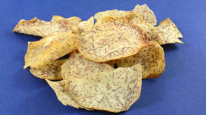 Taro chips with sea salt on a blue background