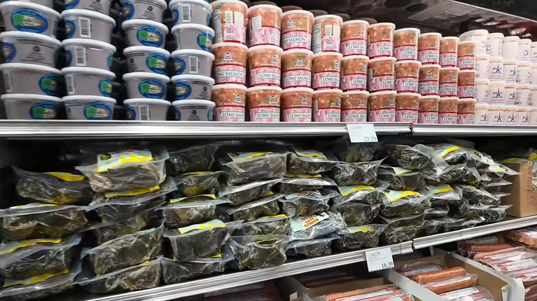 Containers of lomi salmon, seaweed and more on shelves at a Hawaiian Costco