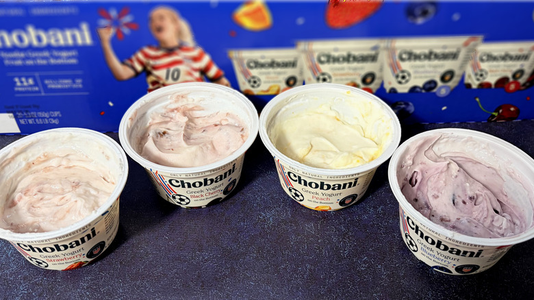 Four open containers of Chobani yogurt in front of box
